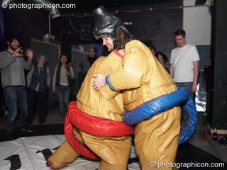 Dave and Charlie play fight in padded pseudo sumo costumes at Dave Green's birthday party. London, Great Britain. © 2007 Photographicon