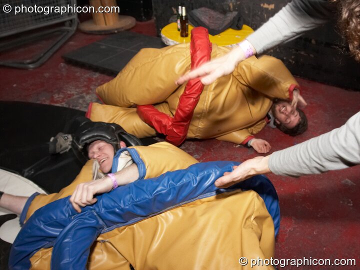 Play fighting in padded pseudo sumo costumes at Dave Green's birthday party. London, Great Britain. © 2007 Photographicon