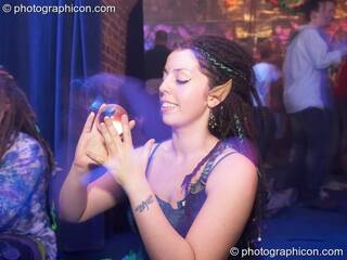 A woman with pixie ears plays with a clear contact ball in  Dakini Records & Gandalf's Garden Party room at Alpha Omega. London, Great Britain. © 2008 Photographicon