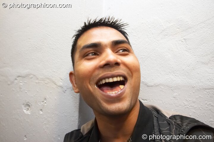 A man with short spiky hair chews gum with his mouth open at Future Music. London, Great Britain. © 2008 Photographicon