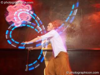 A man spins flashing LED poi in the WorldBeat room at the Haiti Appeal Party 09/04/2010. London, Great Britain. © 2010 Photographicon