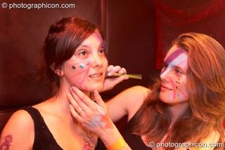 A woman paints another's face at the Electric Circus. London, Great Britain. © 2010 Photographicon