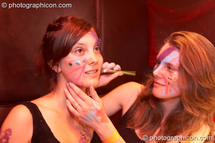 A woman paints another's face at the Electric Circus. London, Great Britain. © 2010 Photographicon