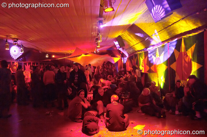 People chilling in the Small World Stage at the Synergy Project. London, Great Britain. © 2005 Photographicon