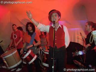Man fronts a drumming band at The Synergy Project. London, Great Britain. © 2005 Photographicon