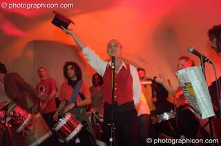 Man fronts a drumming band at The Synergy Project. London, Great Britain. © 2005 Photographicon