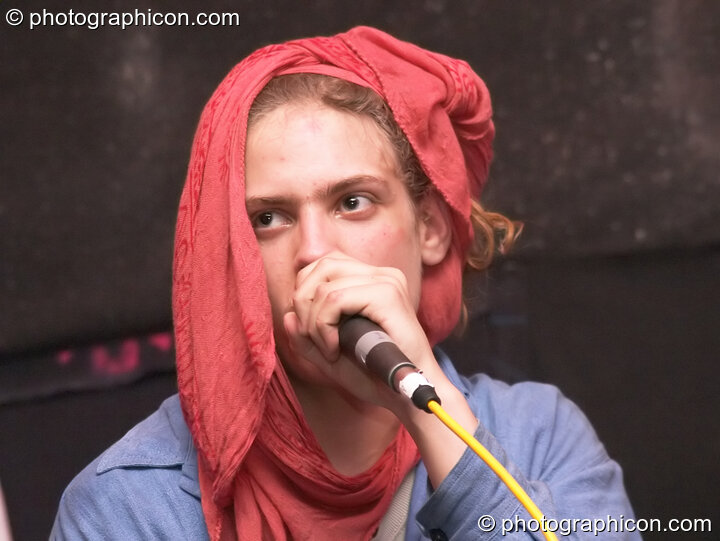 Man in red headscarf spontaneously raps in the Interdimensional Circus space at The Synergy Project. London, Great Britain. © 2005 Photographicon