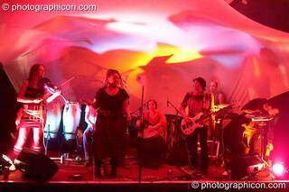 Kate Farbon (violin), Jon "Bongly" Tubmen (percussion), Myo (vocals), Becky Dell (percussion), Pierre Luigi (bass), Pete Ardron (keyboards), and Bagz (electronic percussion) of Orchid Star on the Small World Stage at The Synergy Project. London, Great Britain. © 2006 Photographicon