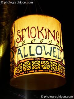 A lantern illuminated sign indicates we are in a designated smoking area at The Synergy Project. London, Great Britain. © 2006 Photographicon