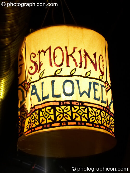 A lantern illuminated sign indicates we are in a designated smoking area at The Synergy Project. London, Great Britain. © 2006 Photographicon