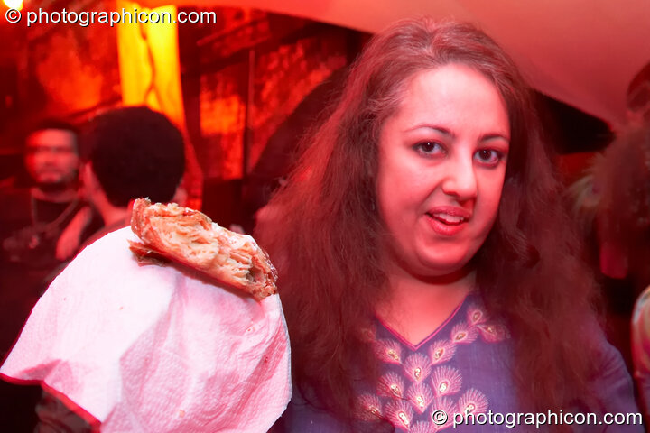 A woman holds a pastry snack at The Synergy Project. London, Great Britain. © 2007 Photographicon