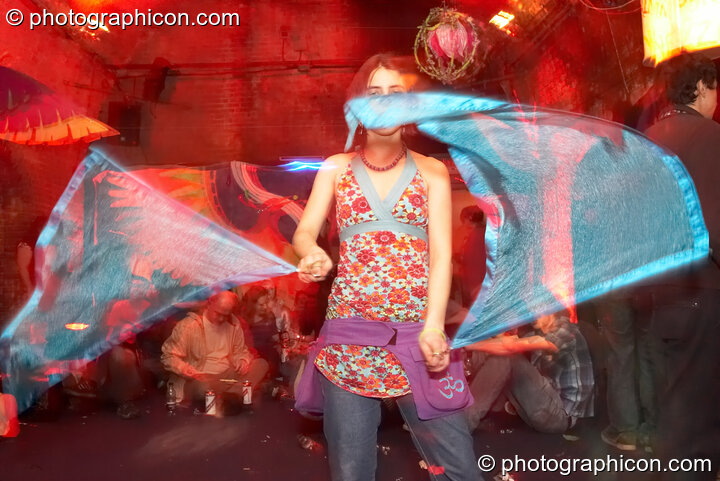 A woman dances while spinning flags in the Kalahari room at The Synergy Project. London, Great Britain. © 2007 Photographicon