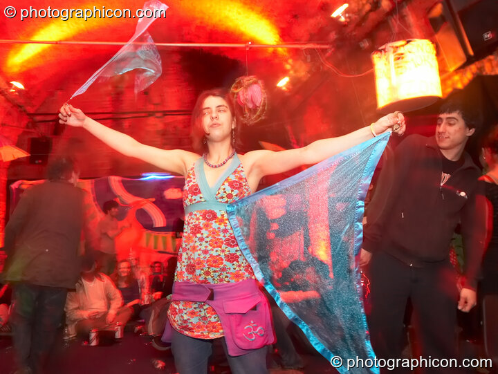 A woman dances while spinning flags in the Kalahari room at The Synergy Project. London, Great Britain. © 2007 Photographicon