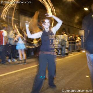 A woman fire-twirls in the road tunnel outside The Synergy Project. London, Great Britain. © 2007 Photographicon