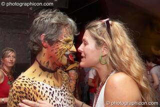 A woman dances with a man in leopard costume at The Synergy Project. London, Great Britain. © 2007 Photographicon
