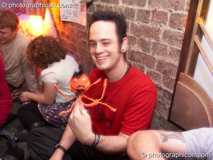 A man holds his creation from the Sea Creature Puppet workshop in the Psycle Laughing Room at The Synergy Project. London, Great Britain. © 2007 Photographicon
