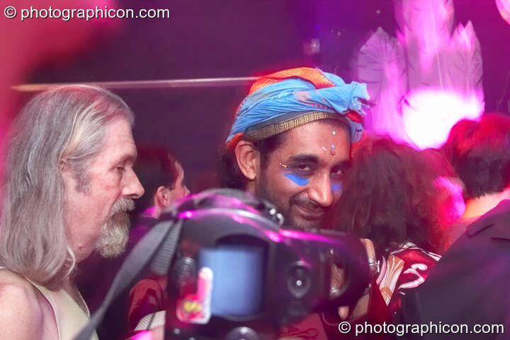 A camera photographs a man in fancy dress at The Synergy Project. London, Great Britain. © 2007 Photographicon