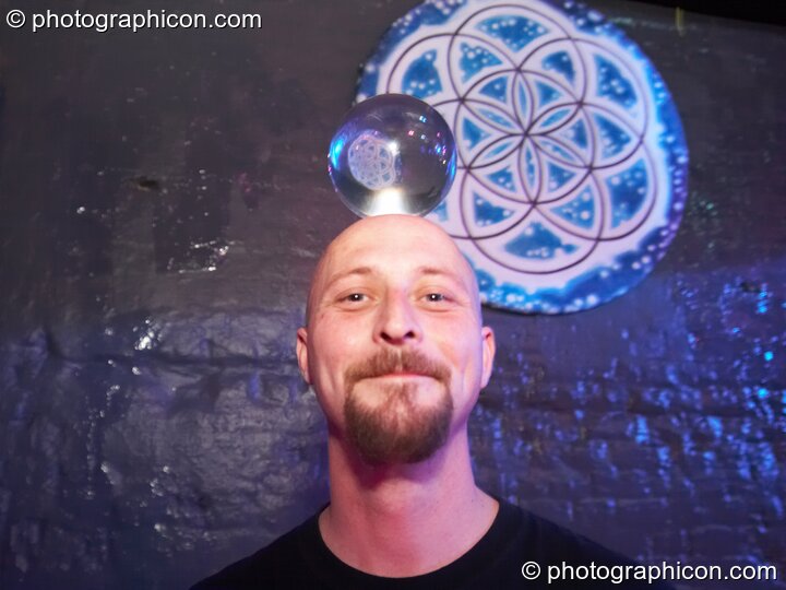 A man balances a transparent jugglin ball on his head in the Liquid Records room at Luminopolis (formerly The Synergy Project). London, Great Britain. © 2008 Photographicon