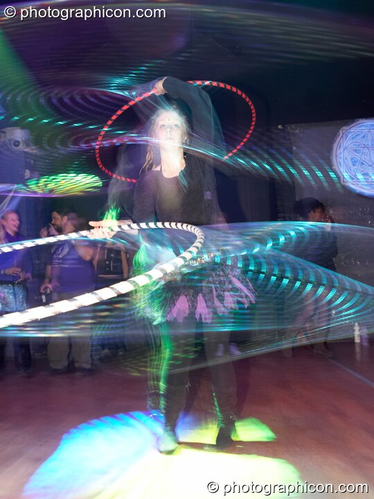 A woman spins a Hula Hoop leaving a light trail  in the Liquid Records room at Luminopolis (formerly The Synergy Project). London, Great Britain. © 2008 Photographicon
