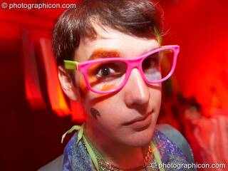 A man wearing wonky pink glasses dances in the Square Roots space at The Synergy Project. London, Great Britain. © 2007 Photographicon