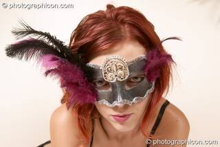 Mistress Sirena (aka Ingrid Pianet) models an erotic costume and feather mask. Surbiton, Great Britain. © 2004 Photographicon