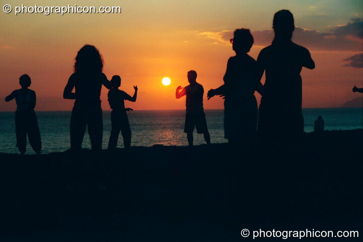 A group of people practising Tai Chi as the sun sets on a cliff at Agios Pavlos. Greece. © 2002 Photographicon