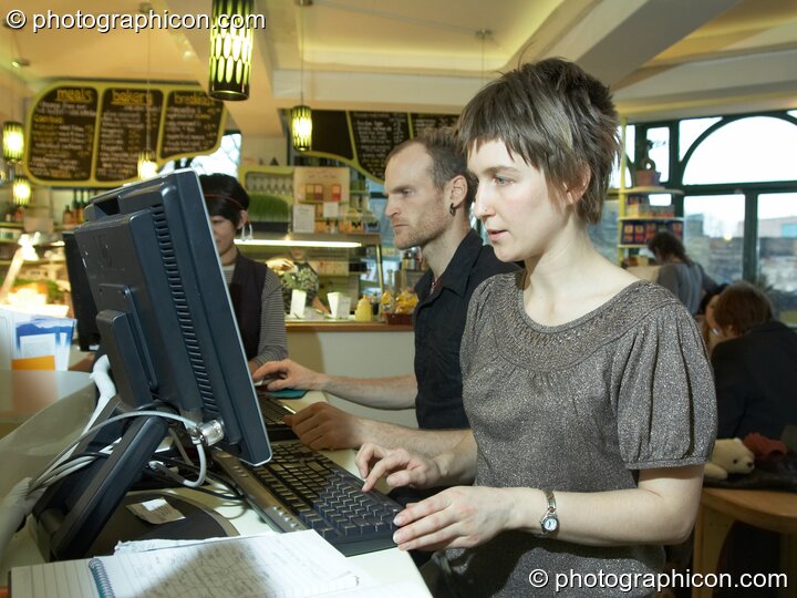 A man and woman use the free Internet terminals in the inSpiral Lounge organic cafe and multimedia venue. London, Great Britain. © 2008 Photographicon