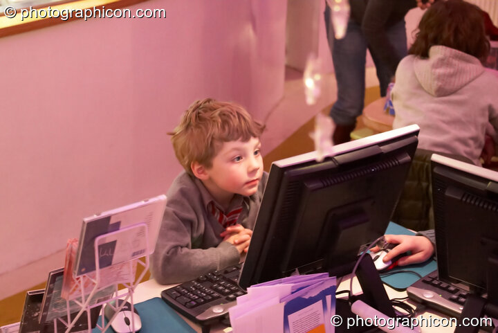 A young boy plays on an Internet terminal in the inSpiral Lounge organic cafe and multimedia venue. London, Great Britain. © 2008 Photographicon