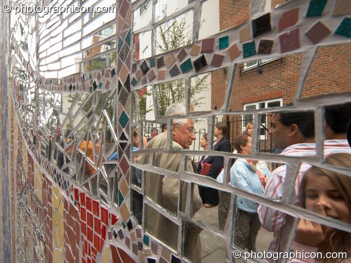 People reflected in the mirror tiles of the Save The World Club's Hundertwasser mosaic. Kingston Upon Thames, Great Britain. © 2005 Photographicon