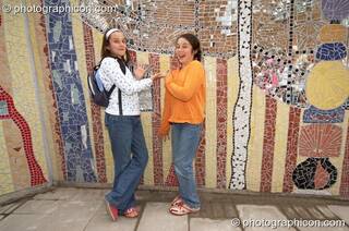 Two girls standing in front of the Save The World Club's Hundertwasser mosaic they helped make. Kingston Upon Thames, Great Britain. © 2005 Photographicon