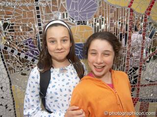 Two girls standing in front of the Save The World Club's Hundertwasser mosaic they helped make. Kingston Upon Thames, Great Britain. © 2005 Photographicon