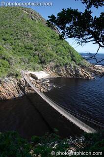 A long foot bridge suspended over Storms River mouth, Tsitsikamma - Eastern Cape, South Africa. © 2005 Photographicon
