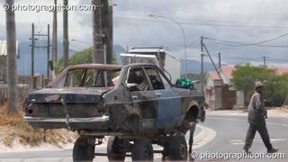 Man with horse and cart transporting the remains of a car in Cape Flats, Cape Town - Western Cape, South Africa. © 2005 Photographicon