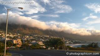 Low cloud pours over the top of Table mountain (an effect known locally as The Table Cloth at the 12 Apostles), Cape Town - Western Cape, South Africa. © 2005 Photographicon