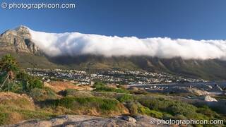 Low cloud (the Table Cloth) pours over the top of Table mountain (the 12 Apostles), Cape Town - Western Cape, South Africa. © 2005 Photographicon