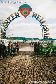 The well-trodden muddy path to the welcoming entrance of Big Green Gathering 2003. Cheddar, Great Britain. © 2003 Photographicon