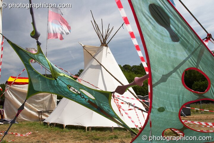 Tipi seen through site decor at Glade Festival 2005. Aldermaston, Great Britain. © 2005 Photographicon