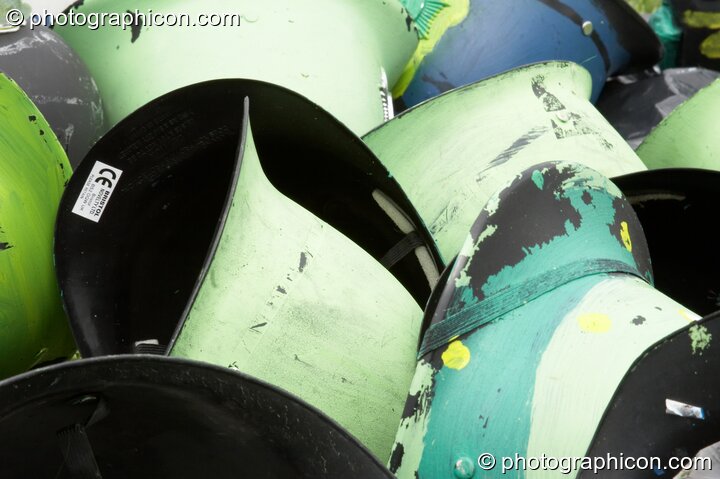 A pile of painted Green Police helmets at Big Green Gathering 2005. Burrington, Cheddar, Great Britain. © 2005 Photographicon