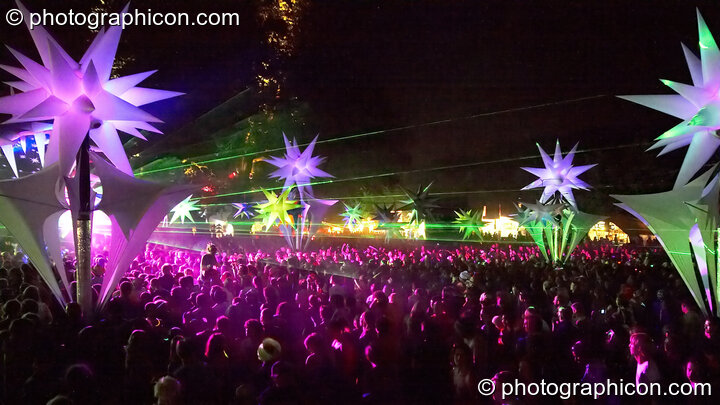A night view from above the crowd of dancers amongst the illuminated inflatable Tribe of Frogs decor by the Origin Stage at Glade Festival 2006. Aldermaston, Great Britain. © 2006 Photographicon