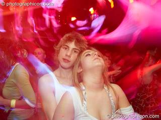 A man and a woman hug while dancing in the IDspiral room at The Synergy Project. London, Great Britain. © 2007 Photographicon