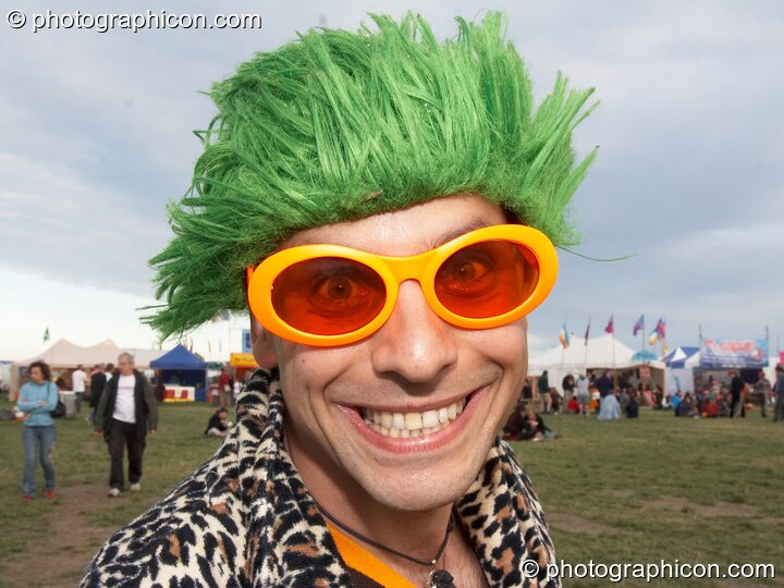 A man dressed to smile in lumo glasses and a green wig at Sunrise Celebration 2007. Yeovil, Great Britain. © 2007 Photographicon