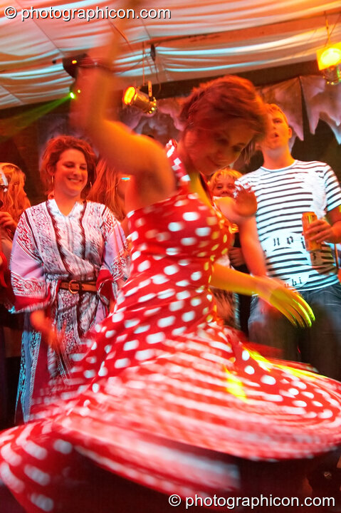 A woman in a red and white Polka dot dress dances in the Mistzfiedmind space at The Synergy Project. London, Great Britain. © 2007 Photographicon
