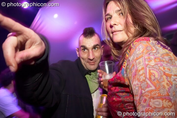 A man with Mohican hair points something out to his girlfriend in the Folktronica room at The Synergy Project. London, Great Britain. © 2008 Photographicon