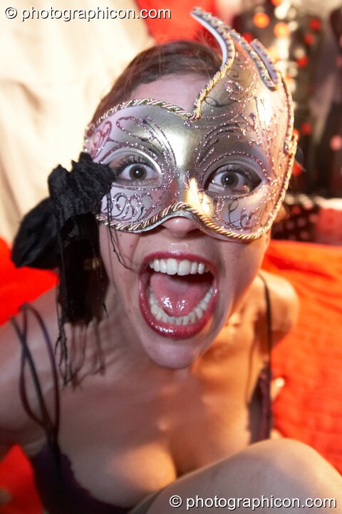 A woman wearing a mask plays on a bed in the Naked room at Electric Circus / Circus2Gaza. London, Great Britain. © 2009 Photographicon