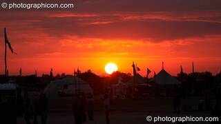 The sun rises over the festival site one day before summer solstice at Sunrise Celebration 2006. Yeovil, Great Britain. © 2006 Photographicon