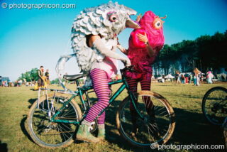 People in fish costumes riding bikes at Big Green Gathering 2003. Cheddar, United Kingdom. © 2003 Photographicon