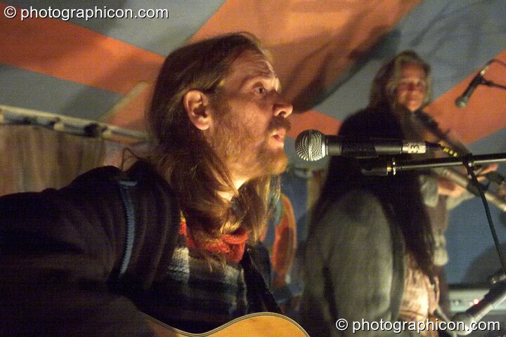 Musicians perform by the light of an oil lamp at Big Green Gathering 2005. Burrington, Cheddar, United Kingdom. © 2005 Photographicon