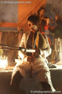 Musicians perform by the light of an oil lamp at Big Green Gathering 2005. Burrington, Cheddar, United Kingdom. © 2005 Photographicon