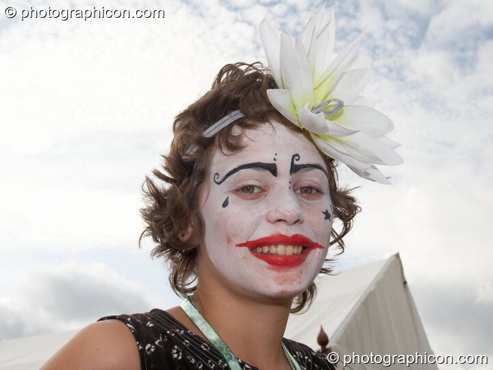 A woman with painted face and a flower in her hair at Big Green Gathering 2006. Burrington, Cheddar, United Kingdom. © 2006 Photographicon