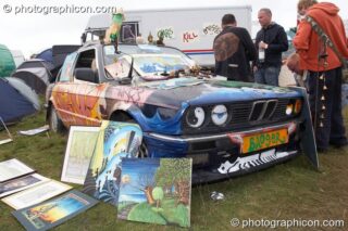 A decoratively painted BMW car forms part of an art stall at Big Green Gathering 2007. Burrington, Cheddar, United Kingdom. © 2007 Photographicon